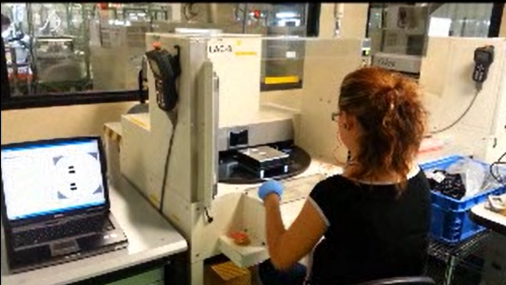 A woman is working on laser engraving at a MIRSA manufacturing facility.